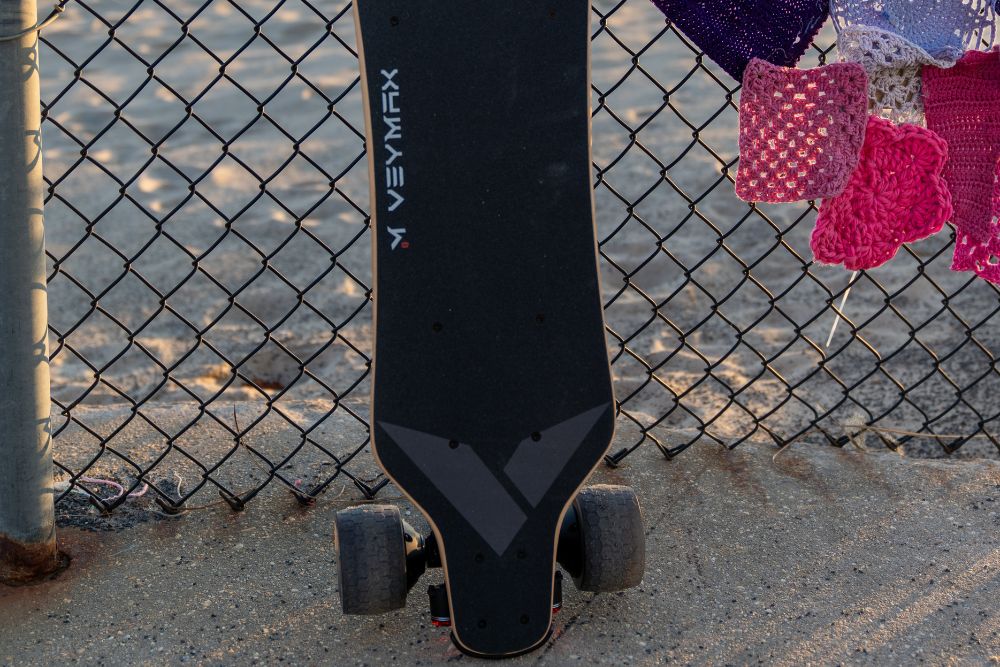 veymax electric skateboard lean on the beach